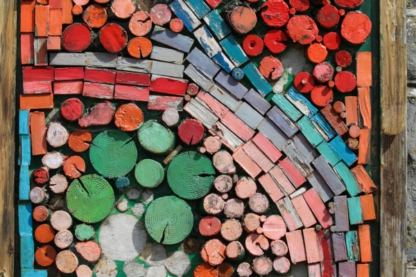 Local Art of colourful timbers on the pier wall at Rush Harbour, County Dublin